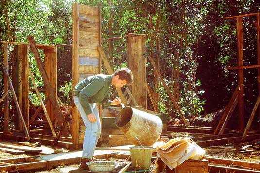 Bob Hemus setting bottles into morter, starting the house walls 